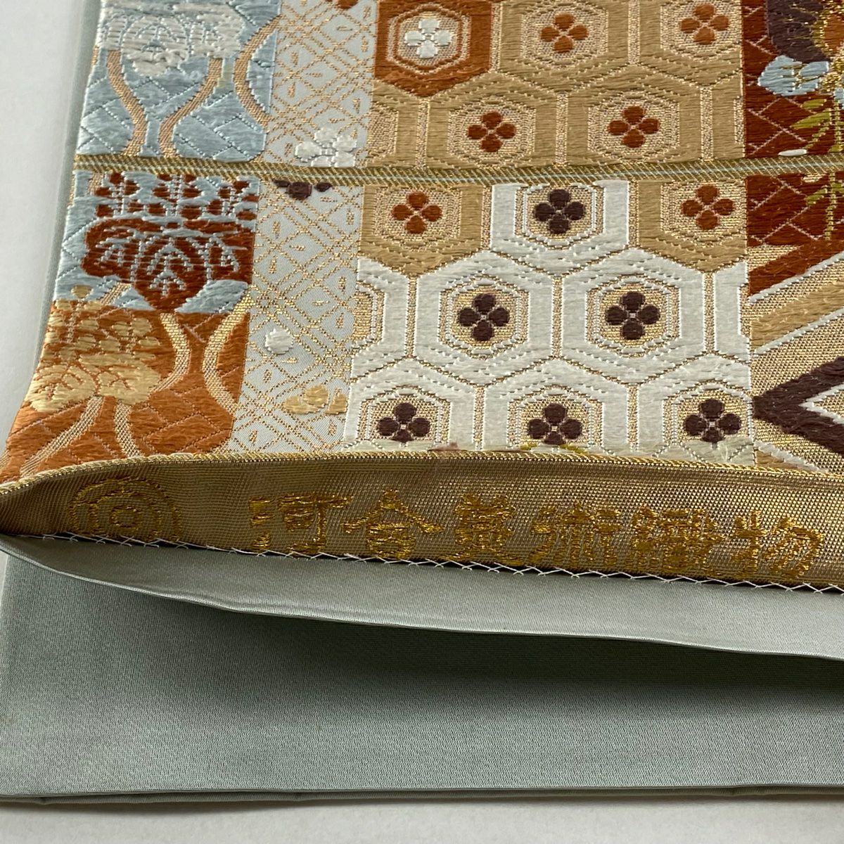 袋帶 逸品級 河合美術織物 落款 草花紋 蝶 唐織 金金箔 橙色 六通 純蠶絲