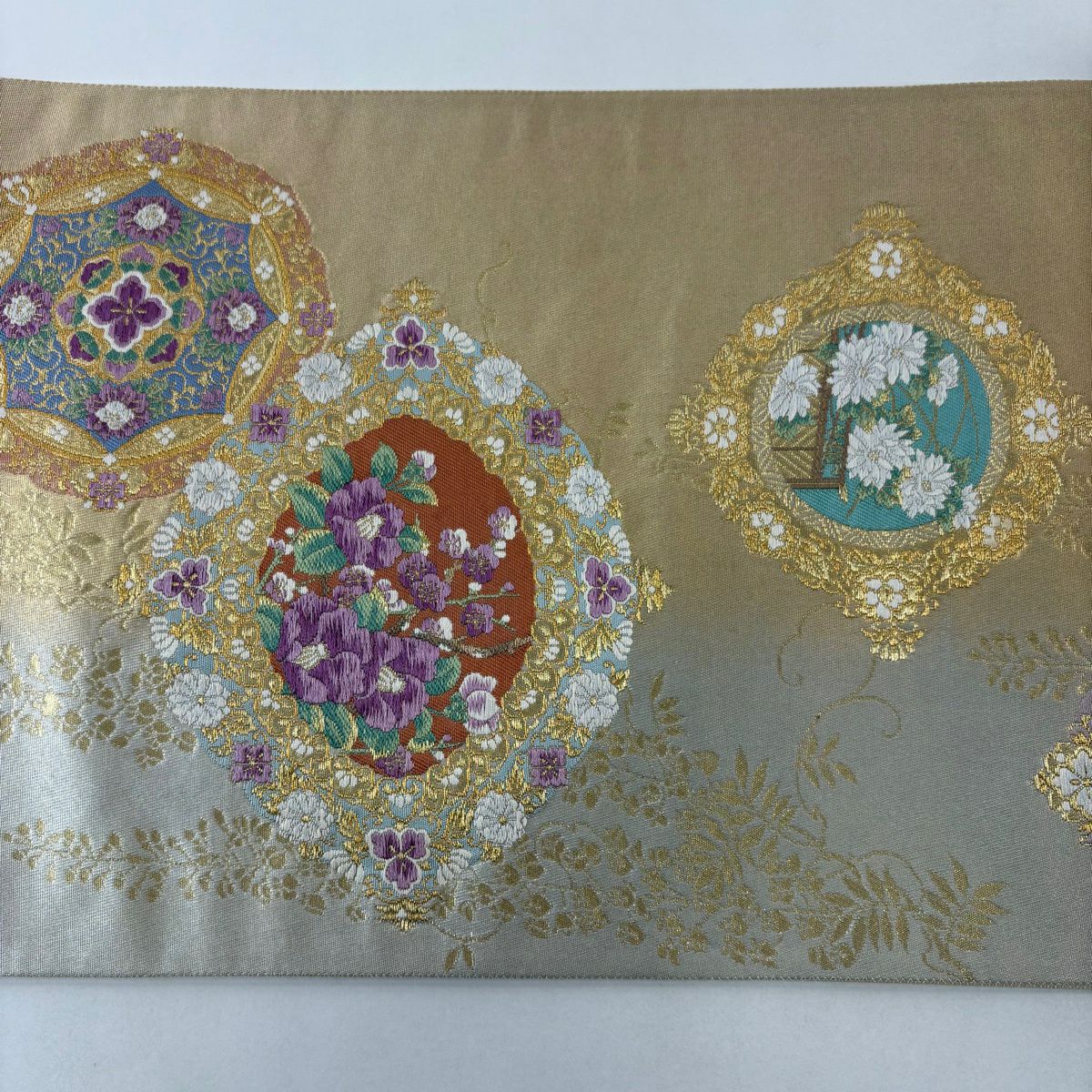 袋帶 名品級 じゅらく 落款あり 帝王紫 華紋 草花紋 唐織 金糸 金色 お太鼓柄 純蠶絲